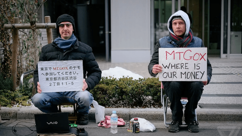 Mt Gox customers wait outside the old offices to ask for their money back